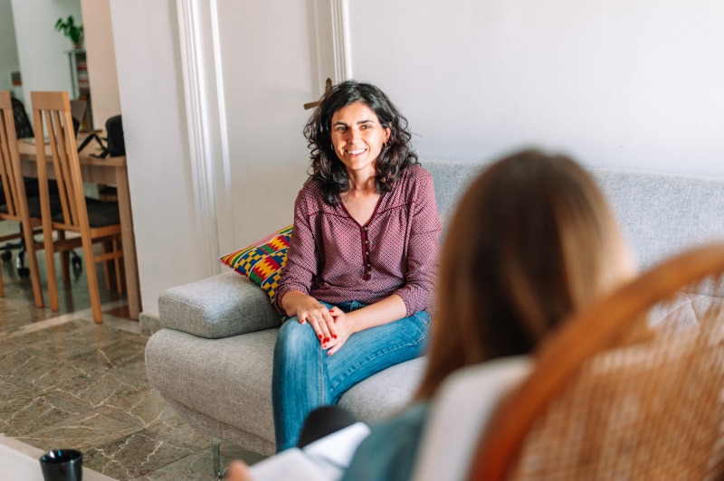 young woman smiles at therapist during a session